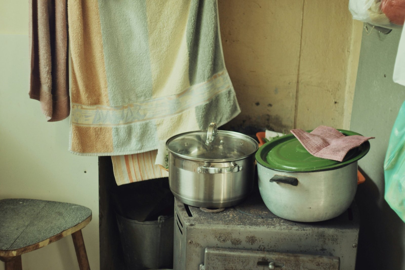 a stove top oven sitting next to a pot on top of a wooden table